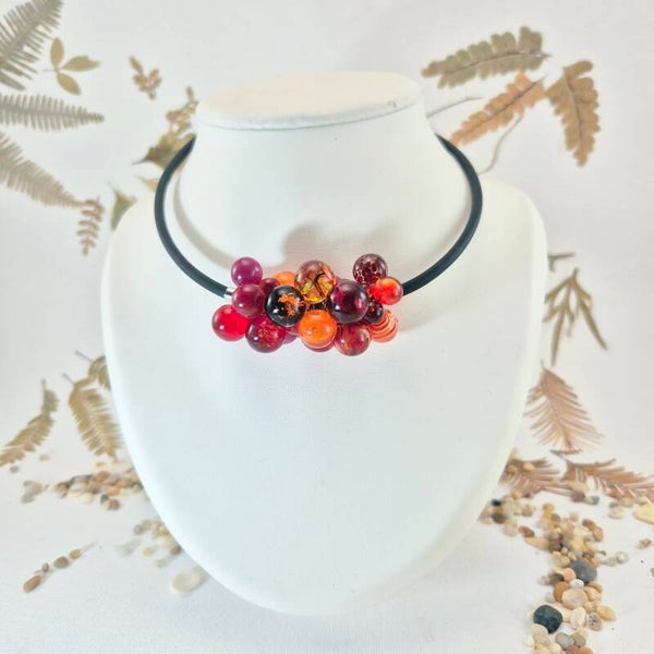 Collier/halsketting met een trosje glasbolletjes in rood, oranje en roze