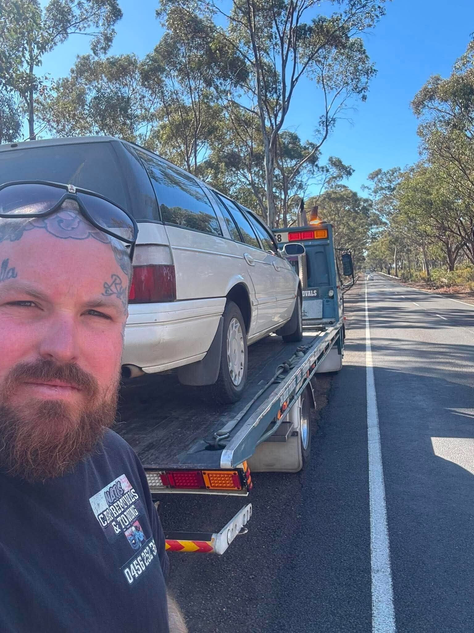 Nath from Nath's Car Removals & Towing with a vehicle loaded on his tilt tray tow truck near Bendigo, Victoria.