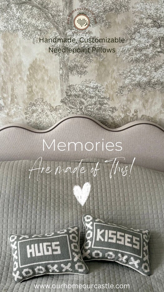 Neutral bedroom styling with decorative handmade needlepoint pillows layered on a cozy bed