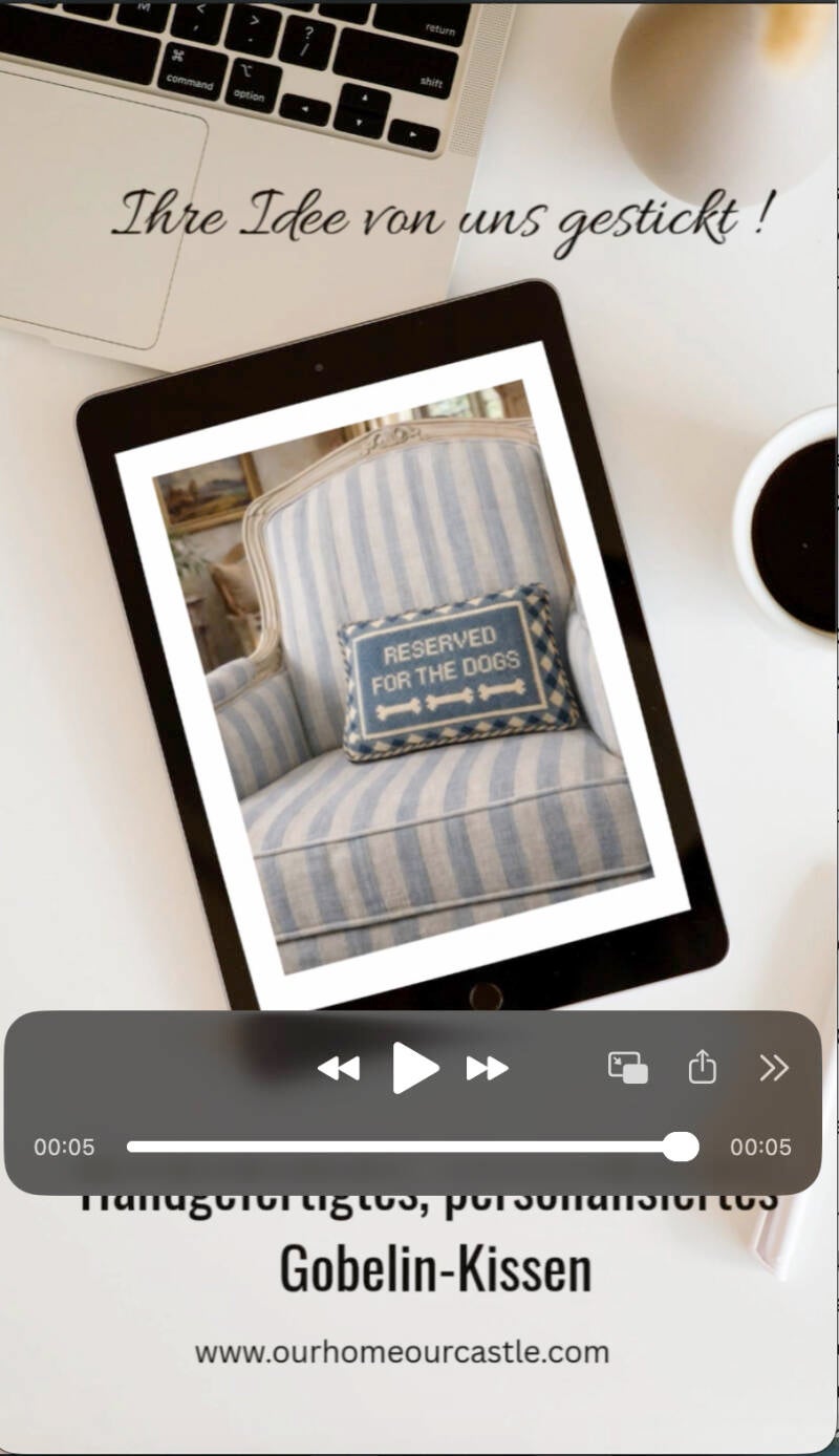 Handmade needlepoint pillow styled on a luxury sofa in a warm European-inspired interior