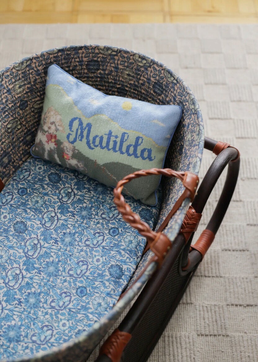 English country cottage interior with vintage-inspired handmade needlepoint cushions and soft floral decor