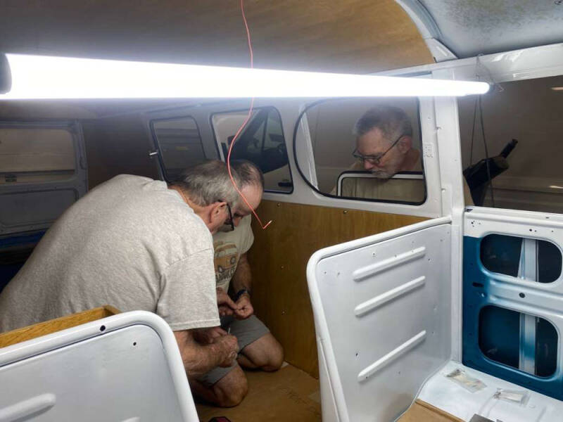 John, Brian, and David inspecting something. Arizona Bus Club