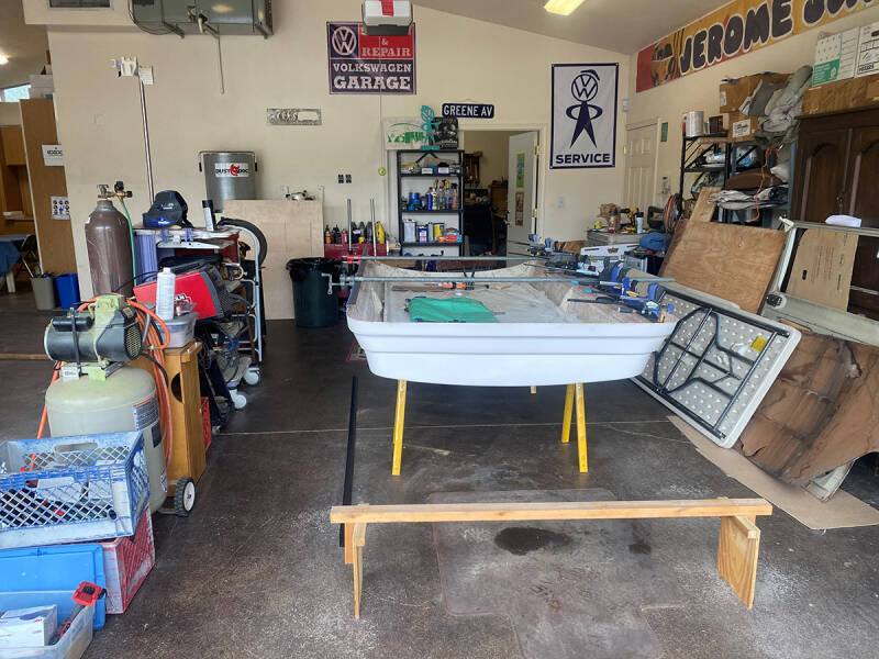 The guys are straightening the top to our 1973 VW Riviera Bus