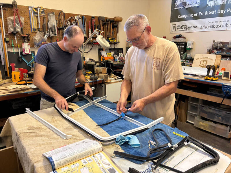 Brian and David working on the sliding windows on the front doors of the Raffle Bus 35. Arizona Bus Club