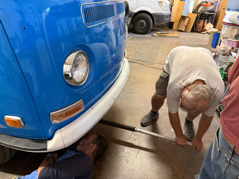 Miller is under the bus, while Dan is managing the jack.