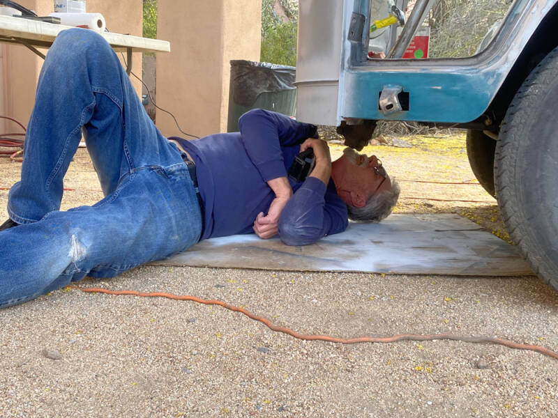 Bill getting a different view of what's going on underneath the Raffle Bus - Arizona Bus Club