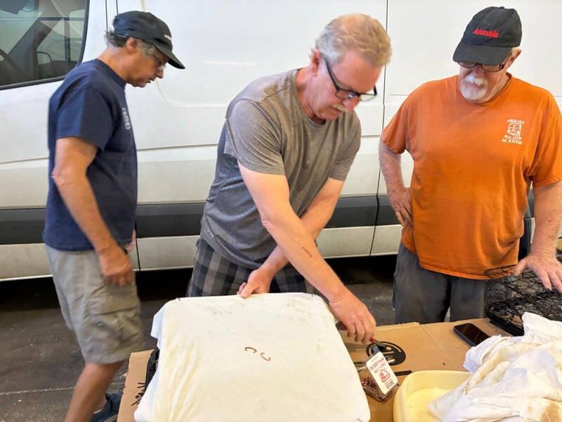 Russell, Brad, and Wayne working on covering the front seats of the Raffle Bus 35. Arizona Bus Cllub