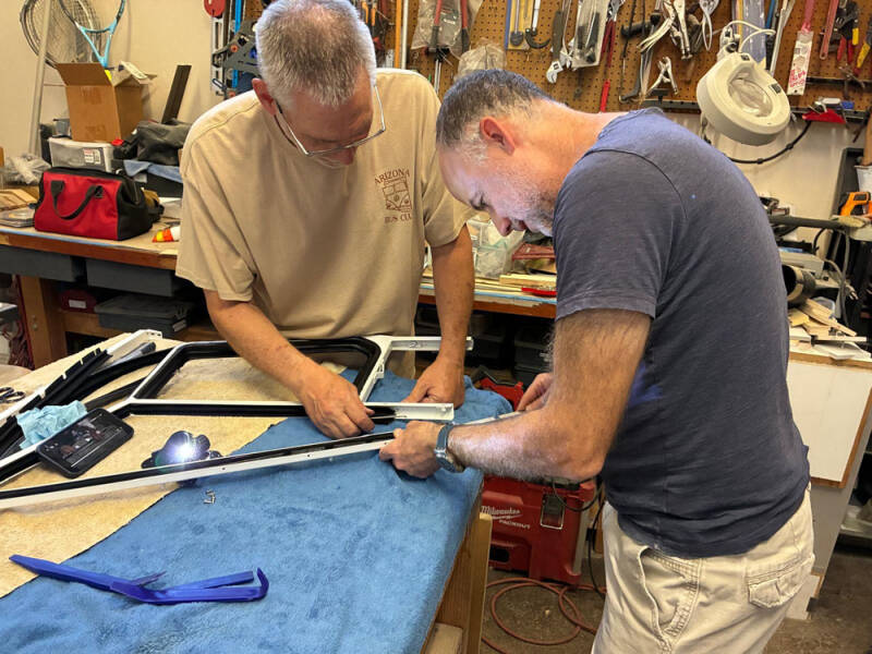David and Brian working on the sliding windows on the front doors of the Raffle Bus 35. Arizona Bus Club