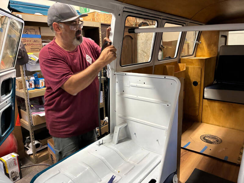 David Pedroza working on raffle bus doors.