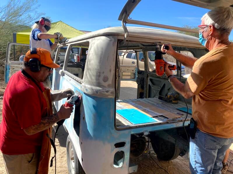 Crew smoothing out the metal.