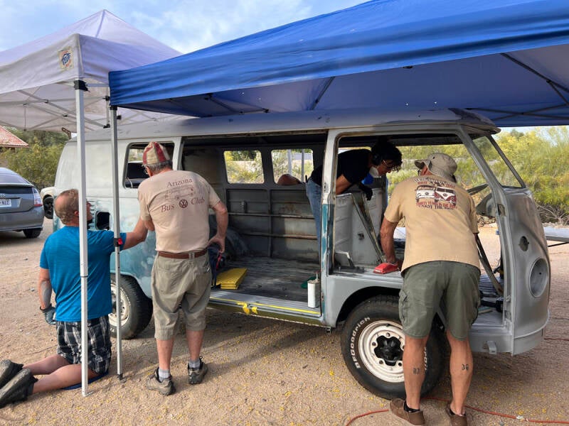 Brad, John, Mindy, and Greg working on different parts of the Raffle Bus - Arizona Bus Club