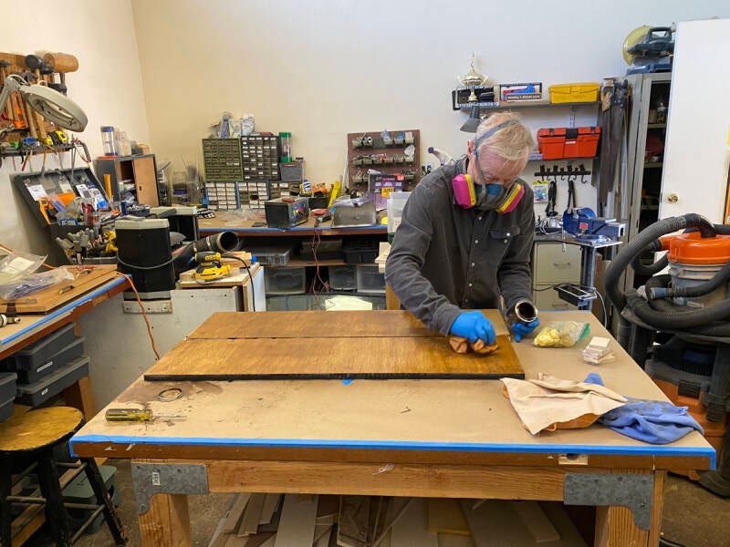 Mark staining wood panels for the Arizona Bus Club Raffle Bus.