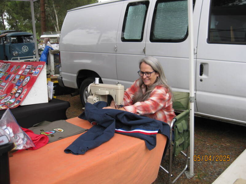 Jane sewing patches on a jacket.