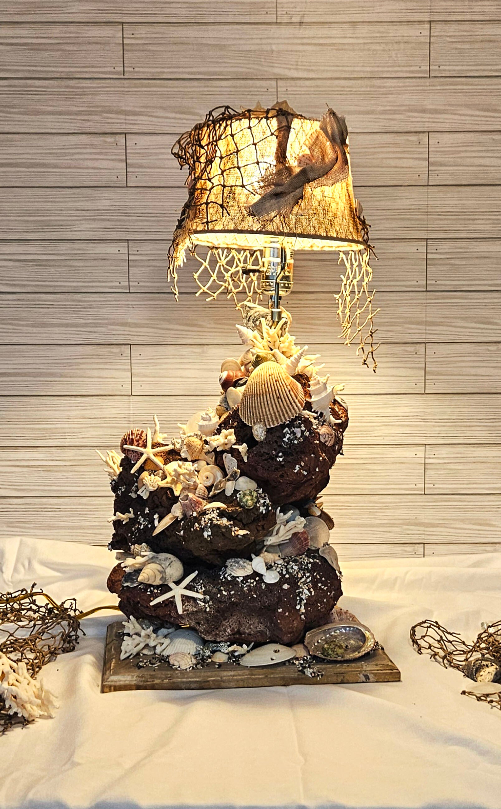 Light of the sea (seashells, light, net, coral, rocks)