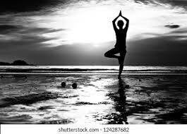 Woman in yoga pose on the beach