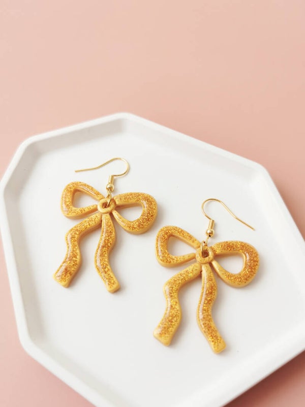 Gouden glitter strik oorbellen