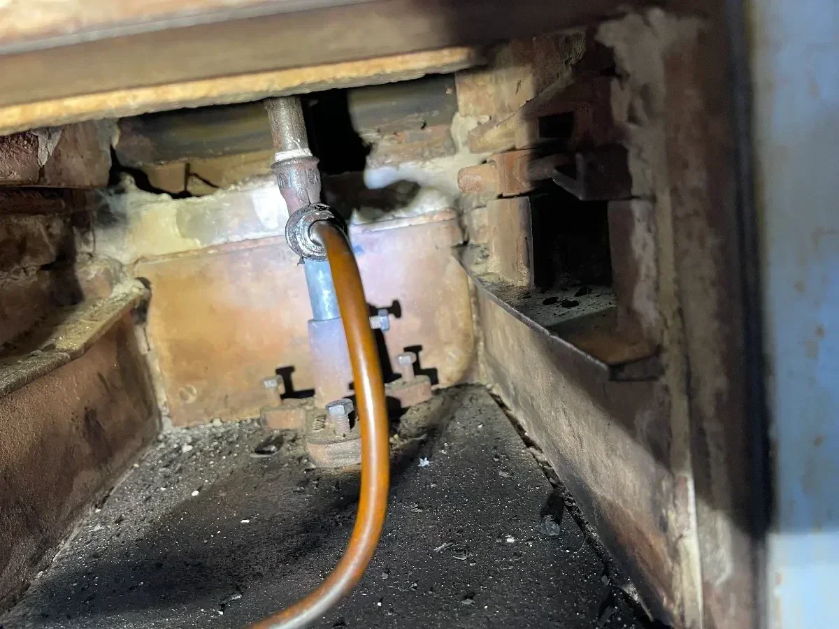 Internal burner and flue components checked during a Navien LCB700 service in Stroud