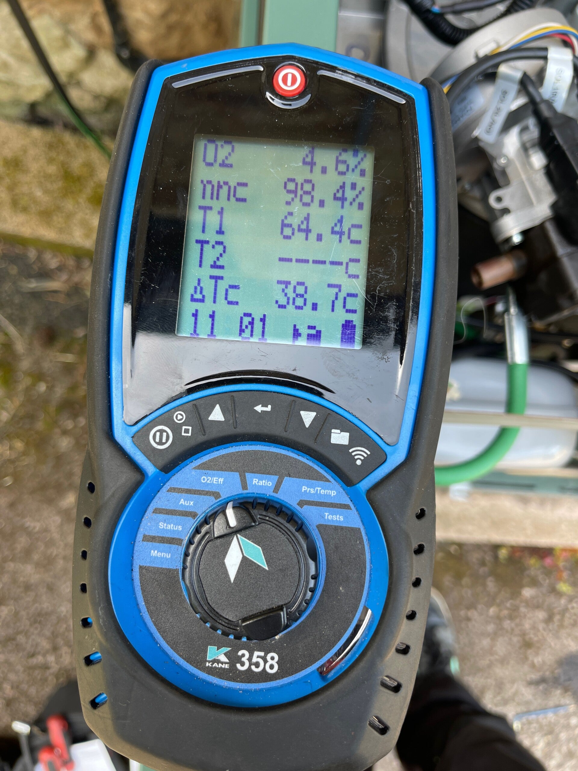 Flue gas analyser showing efficiency and oxygen readings on a serviced Navien LCB700 oil boiler