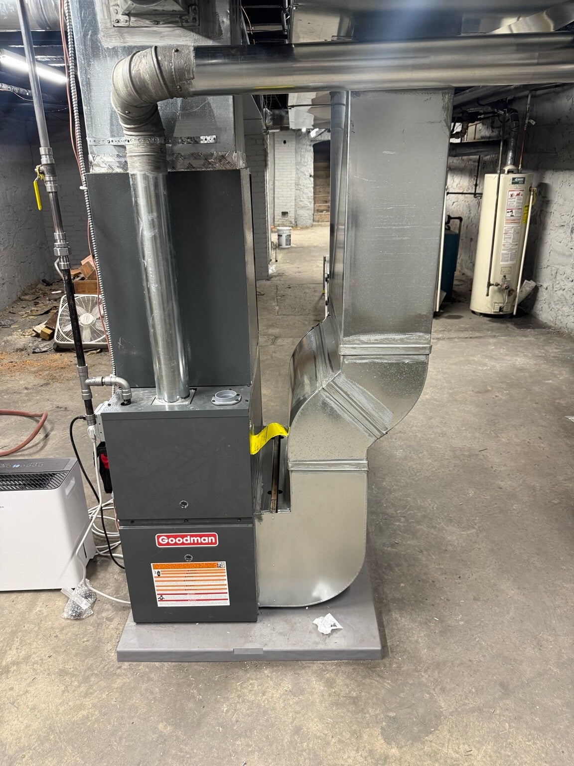 Goodman furnace installation with sheet-metal supply and return ductwork by Skye Heating & Air Conditioning.