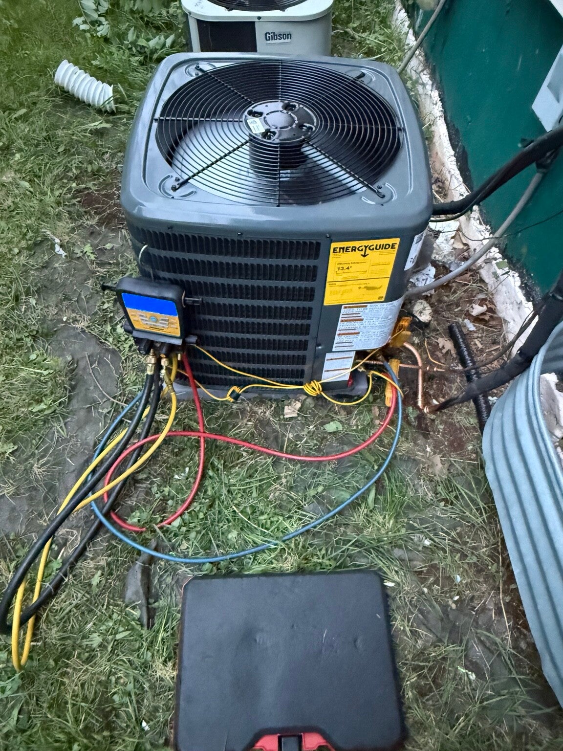 Air conditioner connected to diagnostic gauges during service by Skye Heating & Air Conditioning.