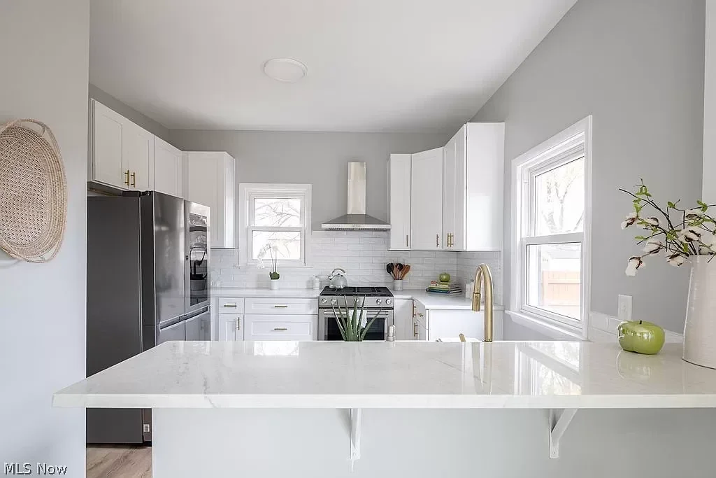 Stunning kitchen remodel with sleek pendant lighting, custom cabinetry, and large island bar