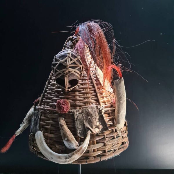 Old conical hat with dyed hair, a boar tusk, tooth and a monkey skull (#603