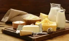 A rustic display of fresh, high-quality dairy items like milk, butter, various cheeses, and cream, showcasing Flossies Fine Foods' premium wholesale food and dairy products for London's top cafes, bakeries, and restaurants.