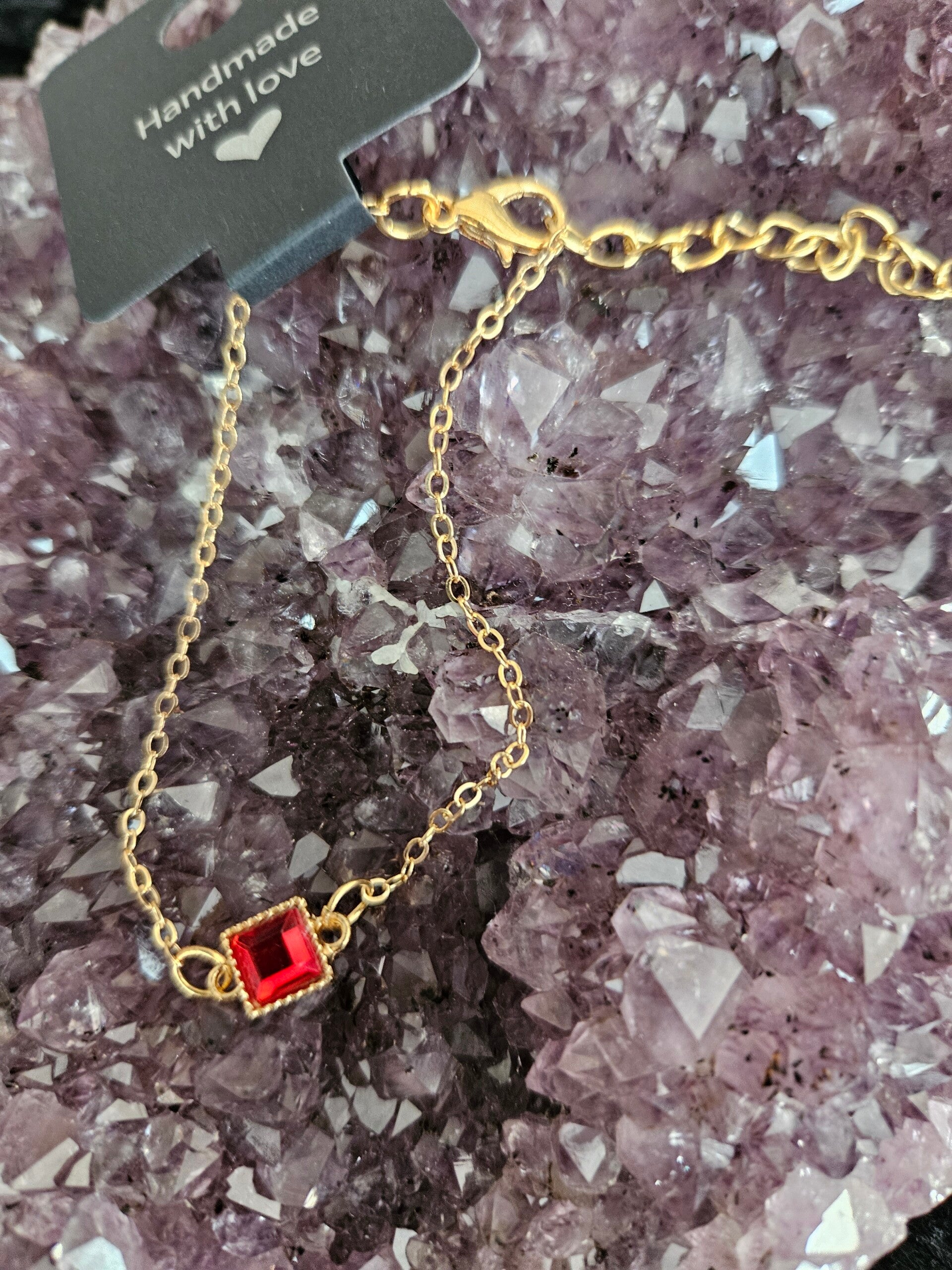 gouden armband rode steen