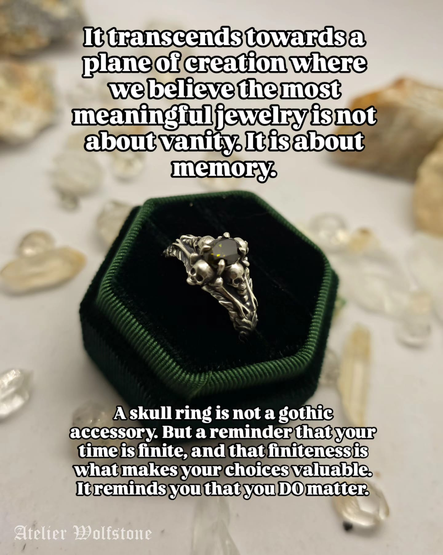 Handmade silver skull ring with a dark green stone in a green velvet ring box, memento mori jewelry by Atelier Wolfstone