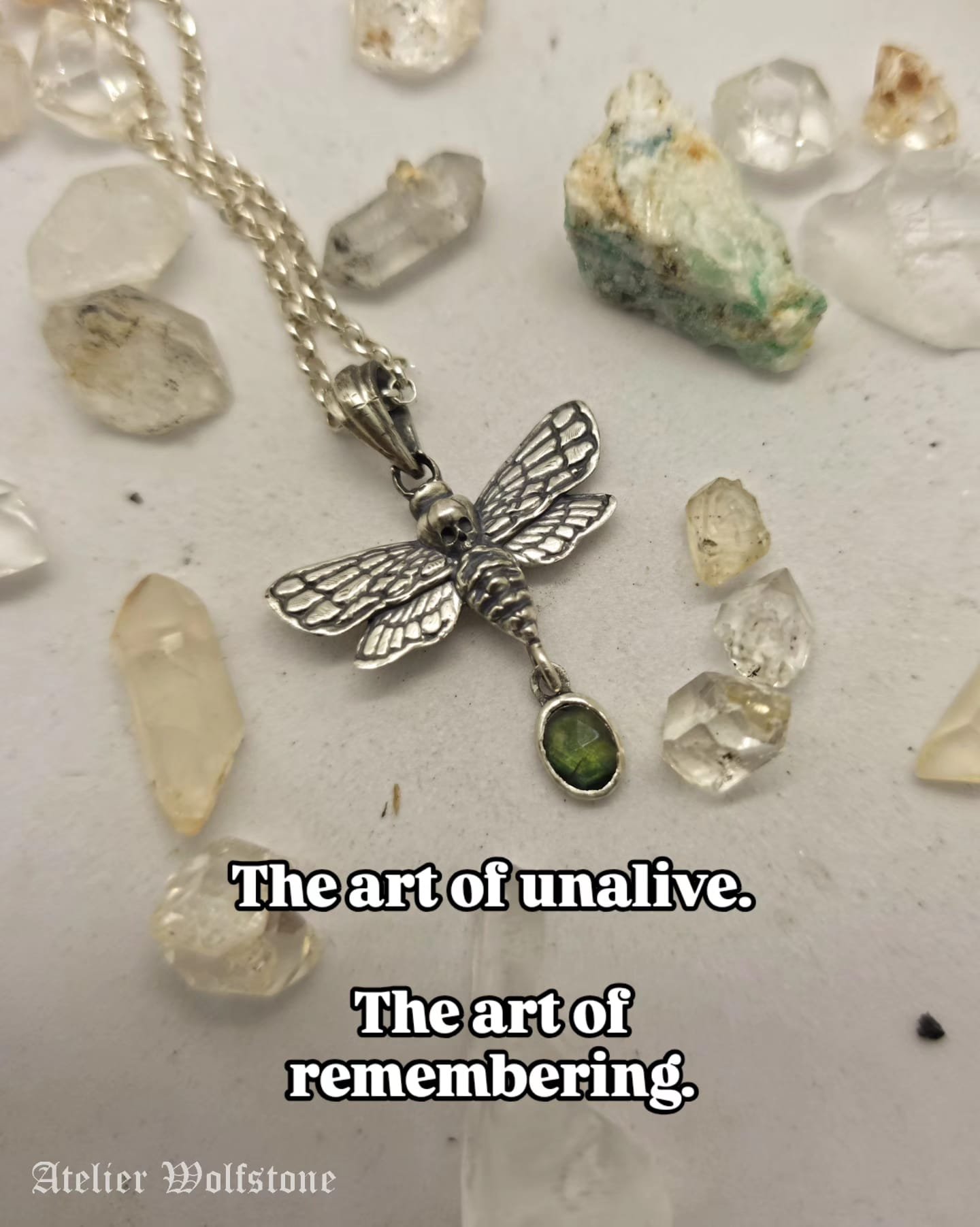 Handmade sterling silver moth pendant with a green stone drop, memento mori and remembrance jewelry by Atelier Wolfstone