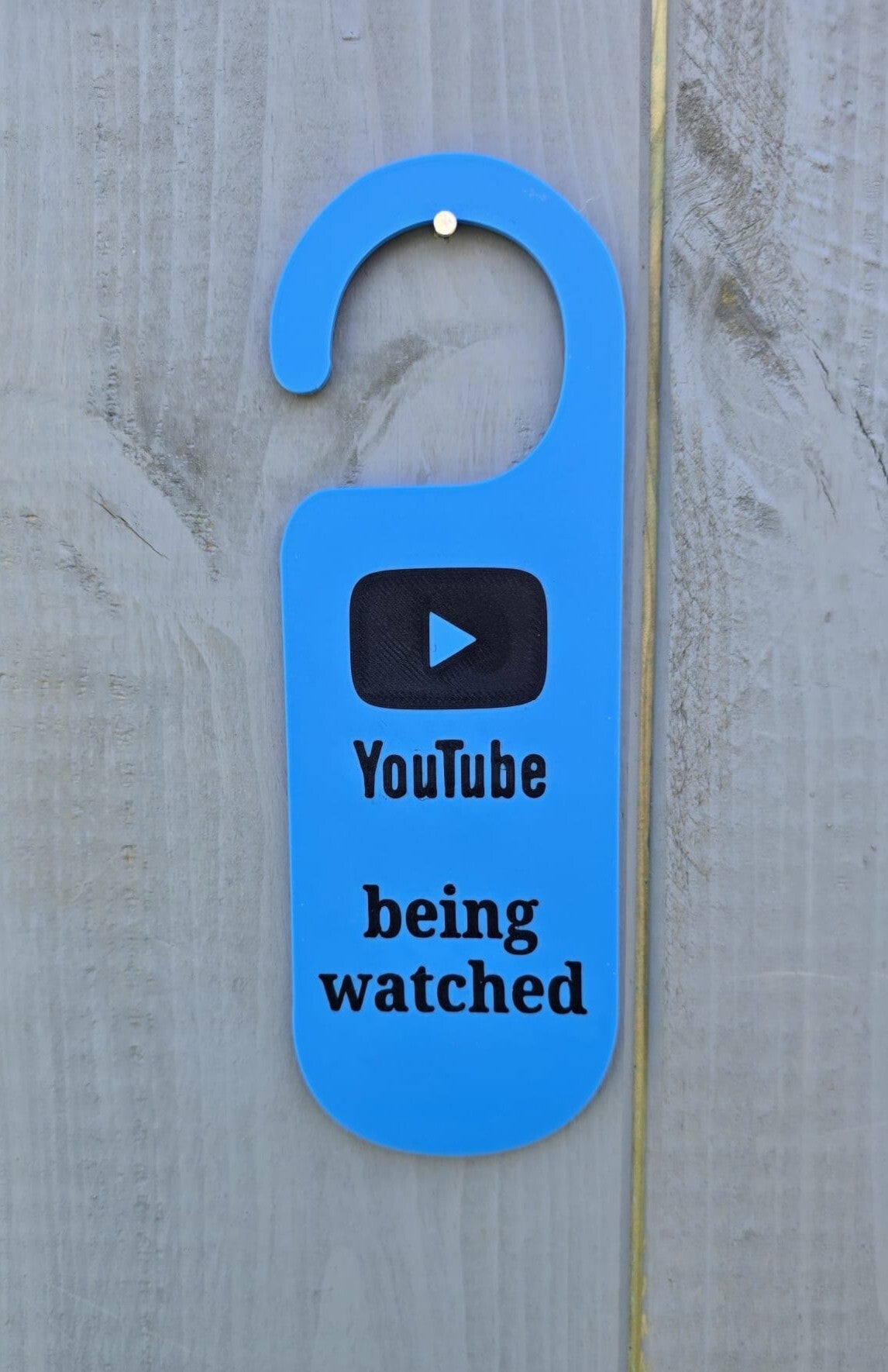 YouTube being watched door hanger