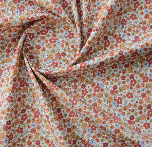 Popelín flores tonos naranjas