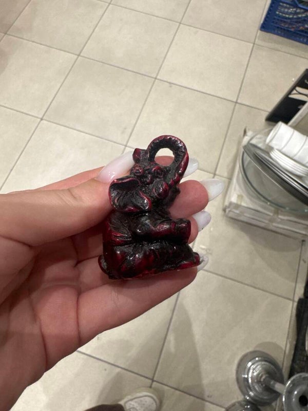 Small seated red and black resin elephant figurine - decoration ***