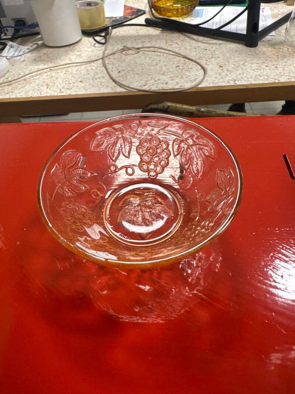 Marigold carnival glass bowl featuring an ambossed grape and leaf pattern - vintage ***