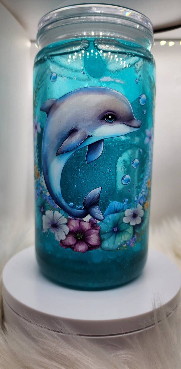 Dolphins in ocean snowglobe tumbler