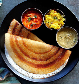 Ghee Dosa – Thin and crispy dosa made from fermented rice-lentil batter, cooked with pure ghee for a rich, golden finish. Served with chutney & sambar.