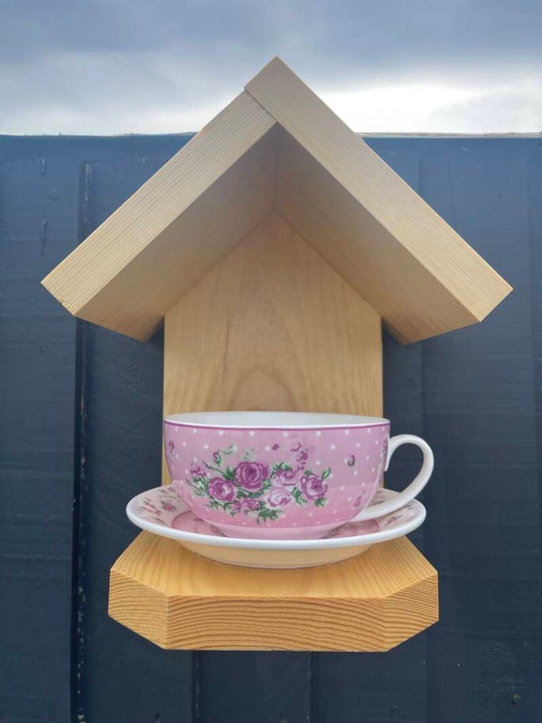 Pink floral teacup and saucer garden feature bird feeder