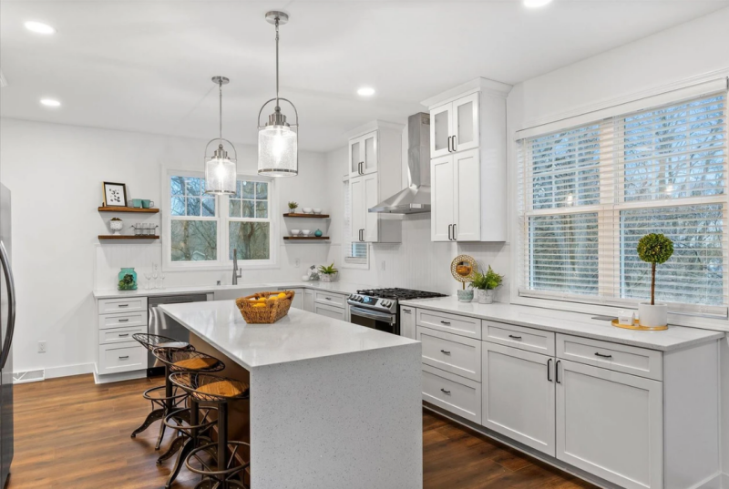 Modern kitchen with smooth, seamless drywall finishes, showcasing expert taping and clean corners around lighting and fixtures.