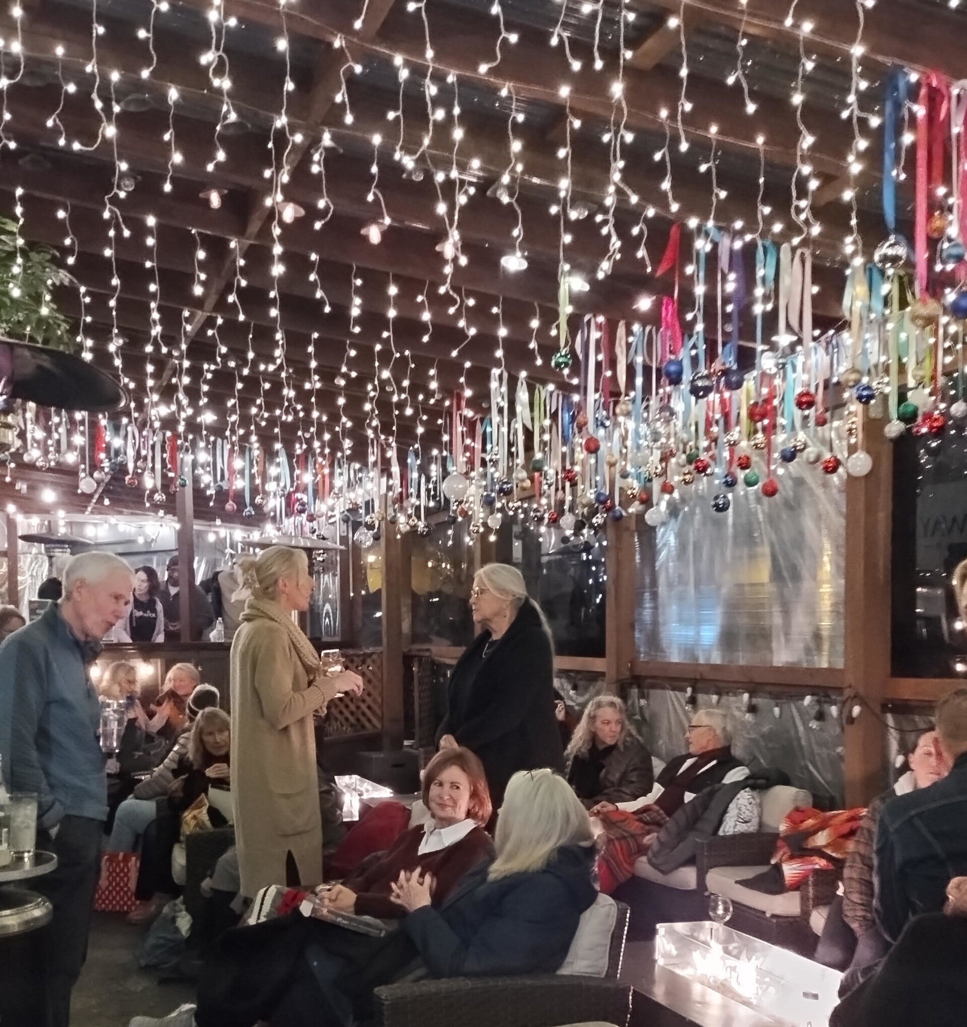 Mac's at 19 Broadway street sign over the patio.