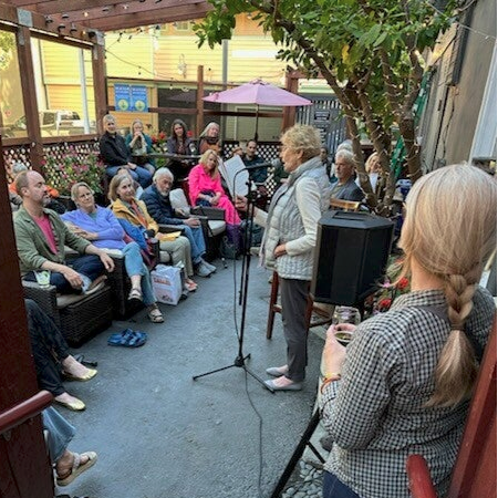 The audience listens to an open mic prose reading