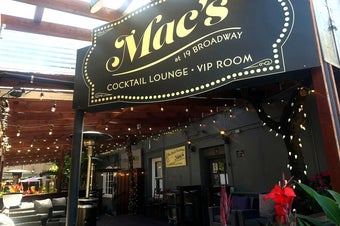 Mac's at 19 Broadway street sign over the patio.