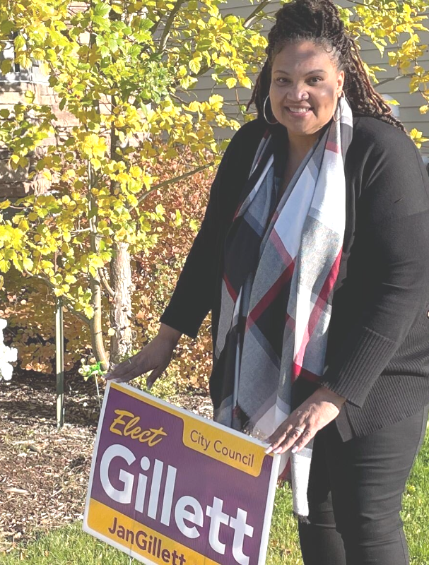 Jan Gillett putting up a campaign lawn sign 