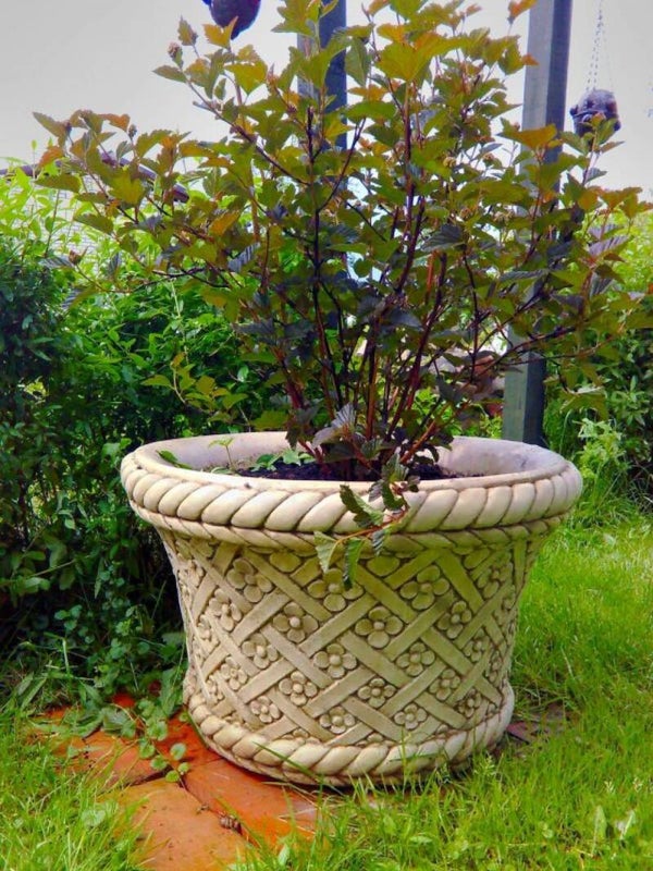 Gartentopf, der einen Blumenkorb imitiert