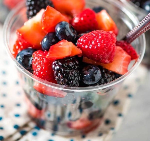 SMALL FRESH FRUIT CUP - A smaller version of fresh seasonal fruits marinated in a light syrup infused with lemon and mint creating a complex and delicate balance of flavors