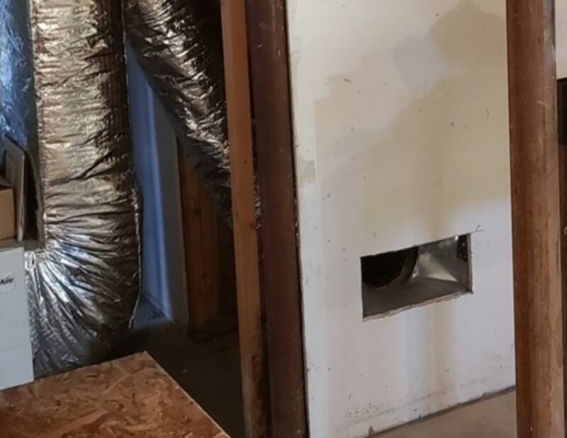 Basement remodel during drywall installation with unfinished surfaces.