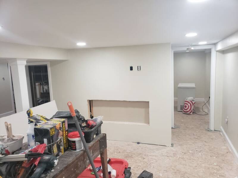 Renovation stage with electrical work and partially finished walls visible.