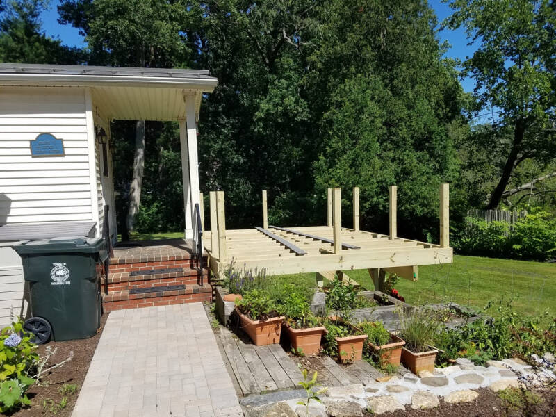 Deck project during installation of decking boards and structural components.