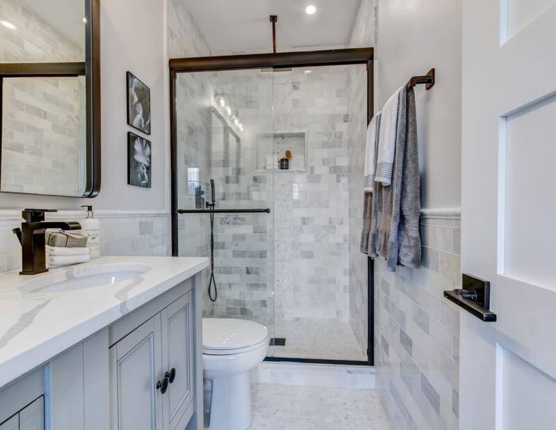 Renovated bathroom with updated tile, modern fixtures, and clean finishes.