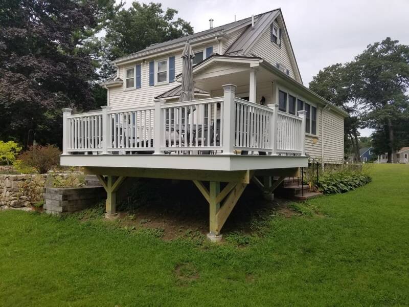 Completed composite deck featuring seating area and clean, modern outdoor design.