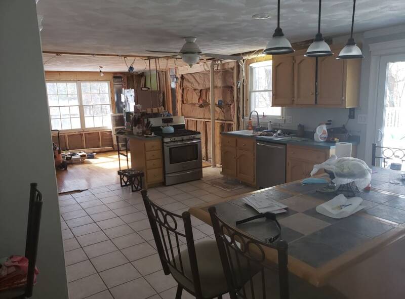 Kitchen before renovation with older cabinets and dated finishes.